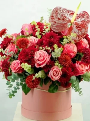 Hearts Passion Bouquet with red and pink roses, chrysanthemums, and anthurium in a pink round box