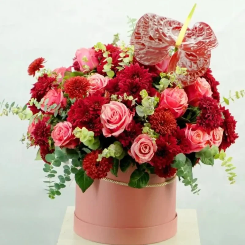 Hearts Passion Bouquet with red and pink roses, chrysanthemums, and anthurium in a pink round box
