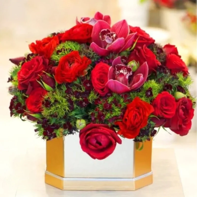 Orchid Secret Bouquet with red roses and orchids in a golden box arrangement