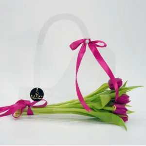 Purple Tulip Bag arrangement in a transparent acrylic handbag with magenta ribbon