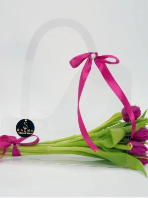 Purple Tulip Bag arrangement in a transparent acrylic handbag with magenta ribbon