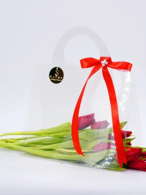 Red Tulip Bag arrangement with fresh tulips in a transparent acrylic handbag