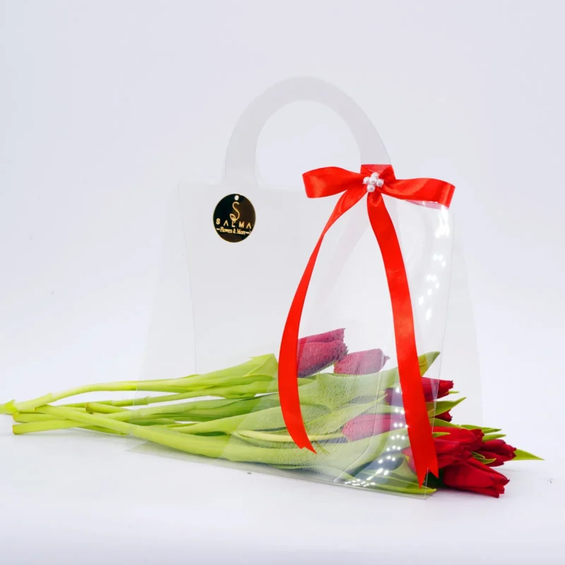 Red Tulip Bag arrangement with fresh tulips in a transparent acrylic handbag
