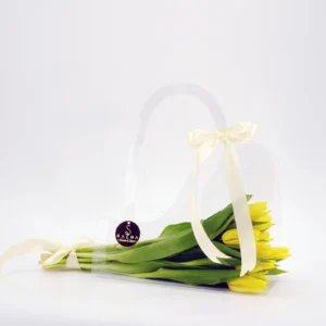 Yellow Tulip Bag arrangement in a transparent acrylic handbag with ivory ribbons