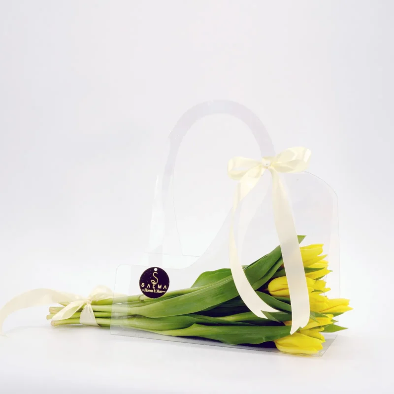 Yellow Tulip Bag arrangement in a transparent acrylic handbag with ivory ribbons