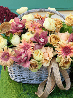 Autumn flower basket with roses, gerbera, and cymbidium orchids