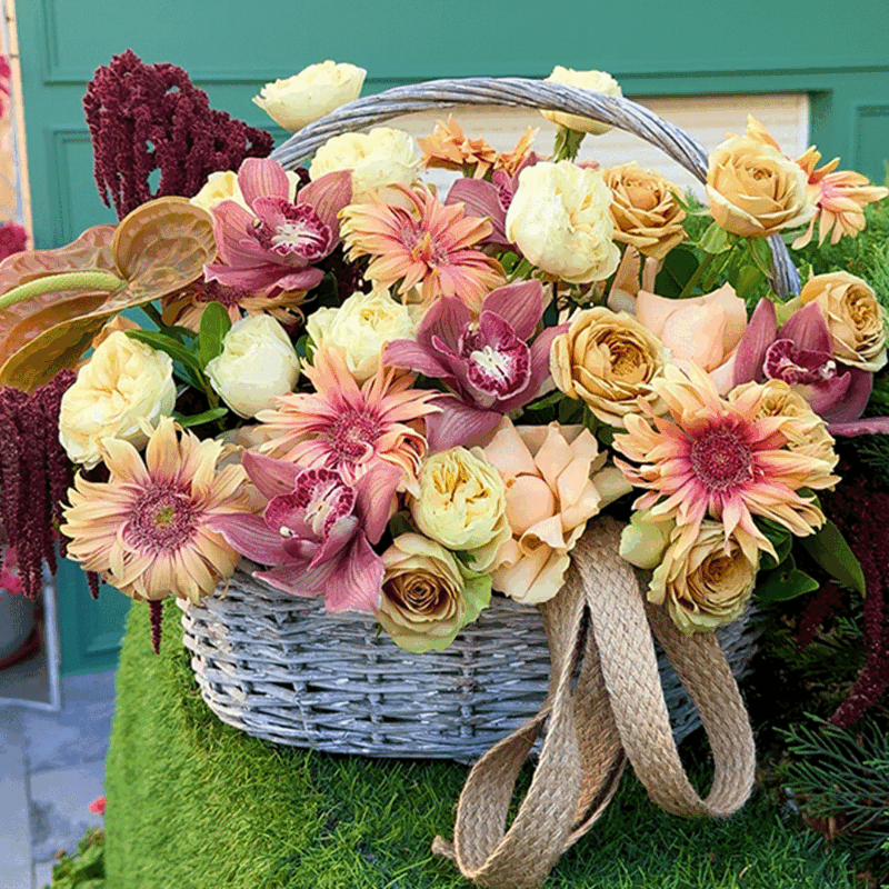 Autumn flower basket with roses, gerbera, and cymbidium orchids