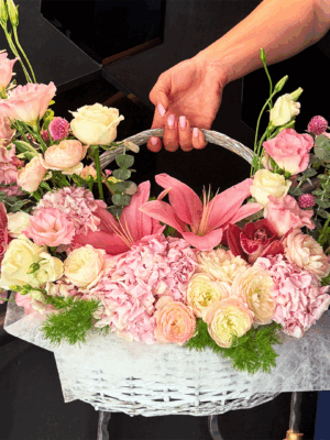 Pink flower basket with lilies, white roses, and hydrangea