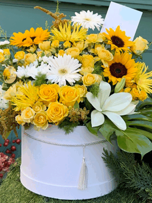 Yellow flower box with roses, gerbera, and chrysanthemums
