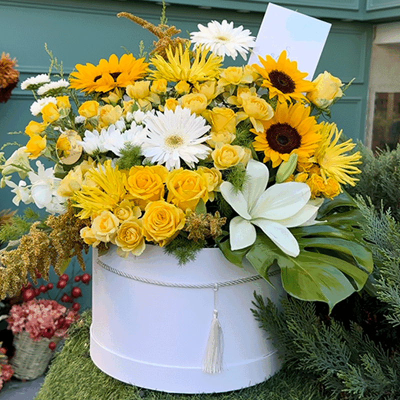 Yellow flower box with roses, gerbera, and chrysanthemums